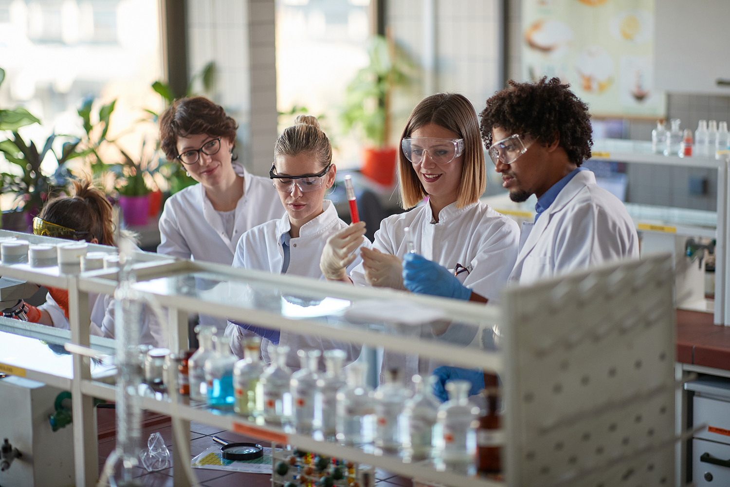 Young students enjoy working with chemicals in a sterile laboratory environment.