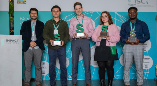 Winners of the Innovation Challenge 2024 (4 men, 1 woman) with their awards infront of ISC3 booth