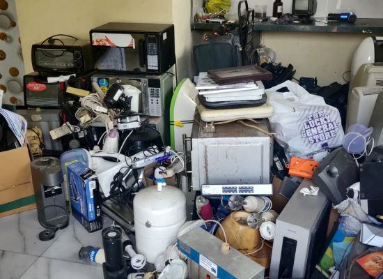 A pile of electronic waste in a room.
