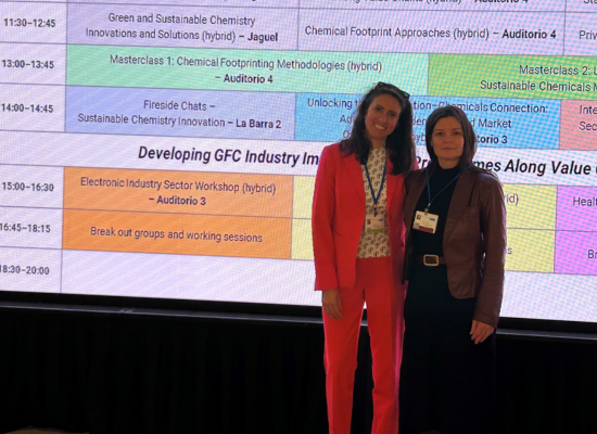 two women standing in front of a projection