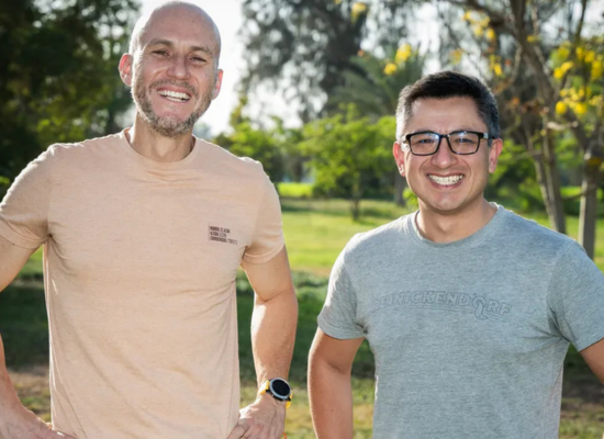 two men smiling at the camera