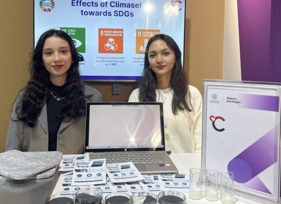 Two women - founders of Climasel at a exhibition booth showcasing their procuct.